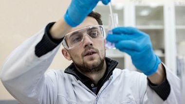 Man with pipette and flask